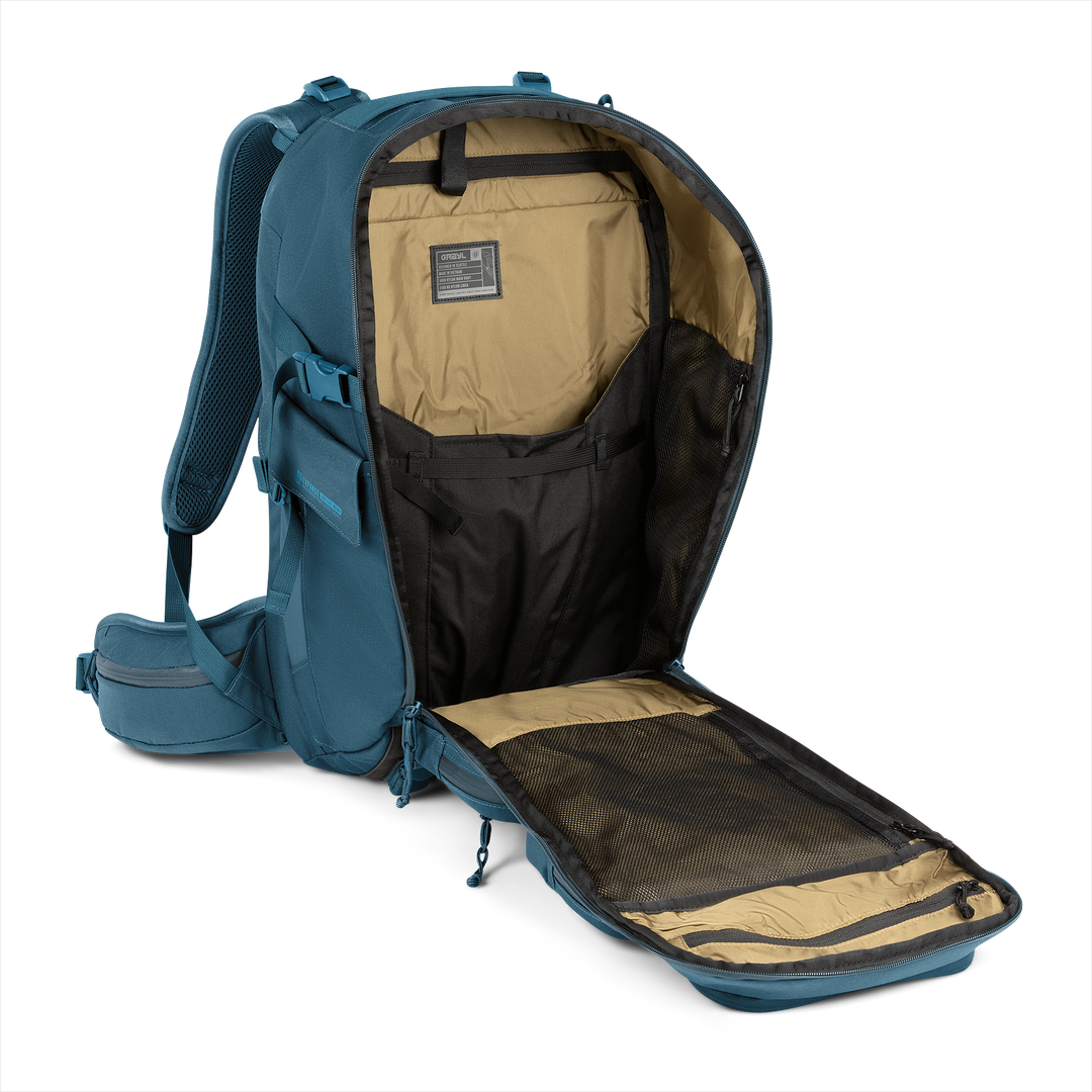 30L Mission Backpack (Wander Blue) with open compartment showing Coyote interior on a white background / Wander Blue
