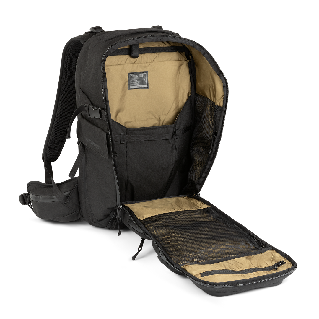 35L Mission Backpack (Covert Black) with open compartment showing Coyote interior on a white background / Covert Black