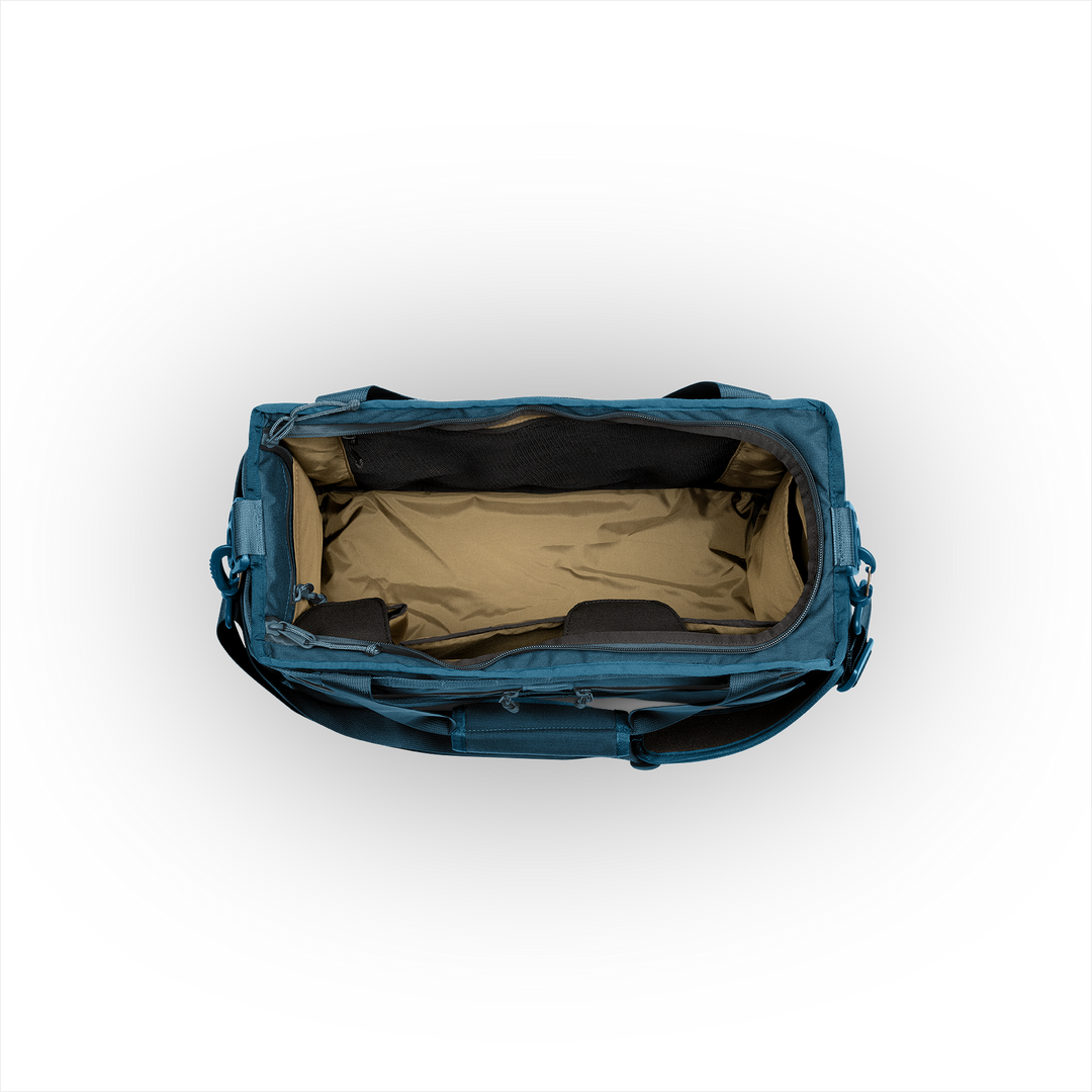 32L Mission Hauler Tote (Wander Blue) with main compartment open showing Coyote interior and pockets on a white background / Wander Blue