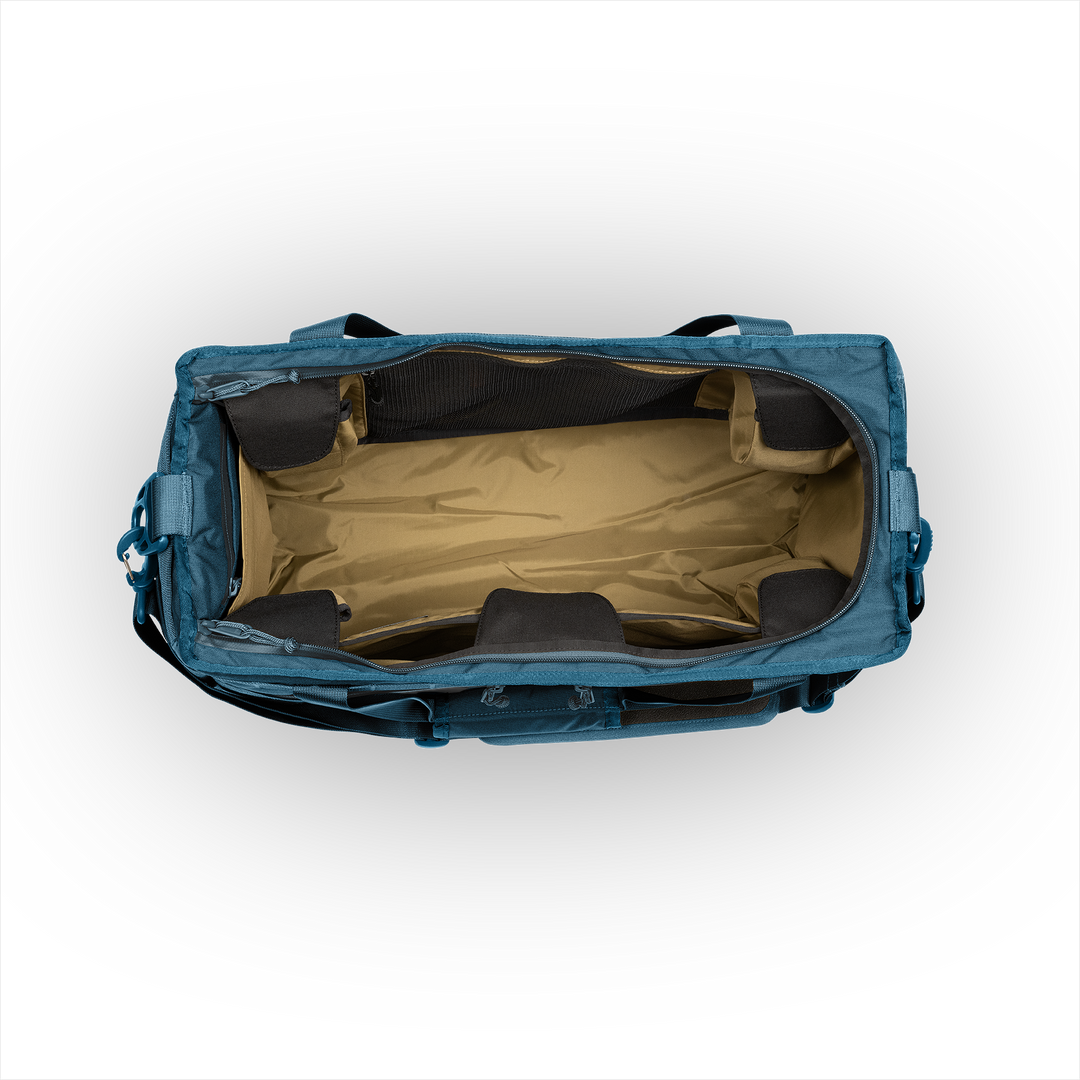 45L Mission Hauler Tote (Wander Blue) with main compartment open showing Coyote interior and pockets on a white background / Wander Blue