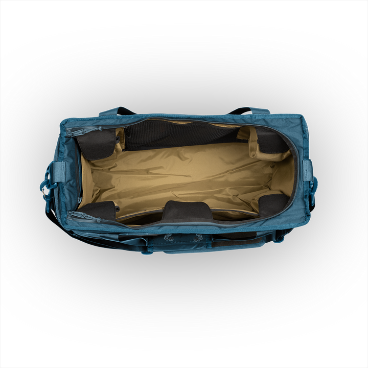 45L Mission Hauler Tote (Wander Blue) with main compartment open showing Coyote interior and pockets on a white background / Wander Blue