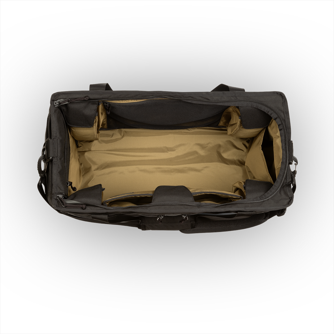 58L Mission Hauler Tote (Covert Black) with main compartment open showing Coyote interior and pockets on a white background / Covert Black