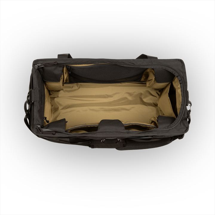 58L Mission Hauler Tote (Covert Black) with main compartment open showing Coyote interior and pockets on a white background / Covert Black