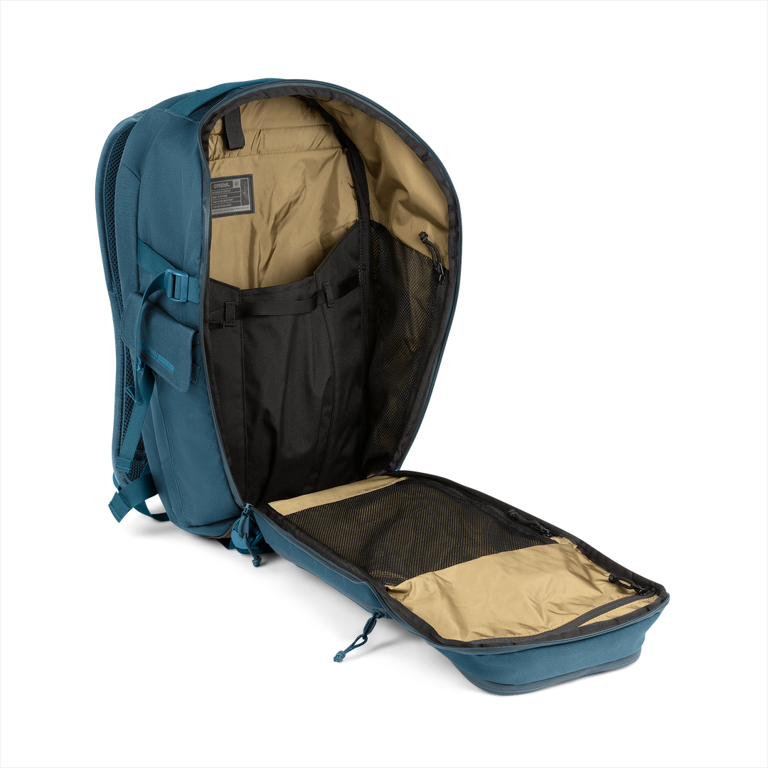 25L Transport Backpack (Wander Blue) with open compartment showing Coyote interior on a white background / Wander Blue