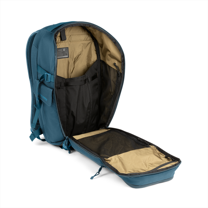 25L Transport Backpack (Wander Blue) with open compartment showing Coyote interior on a white background / Wander Blue