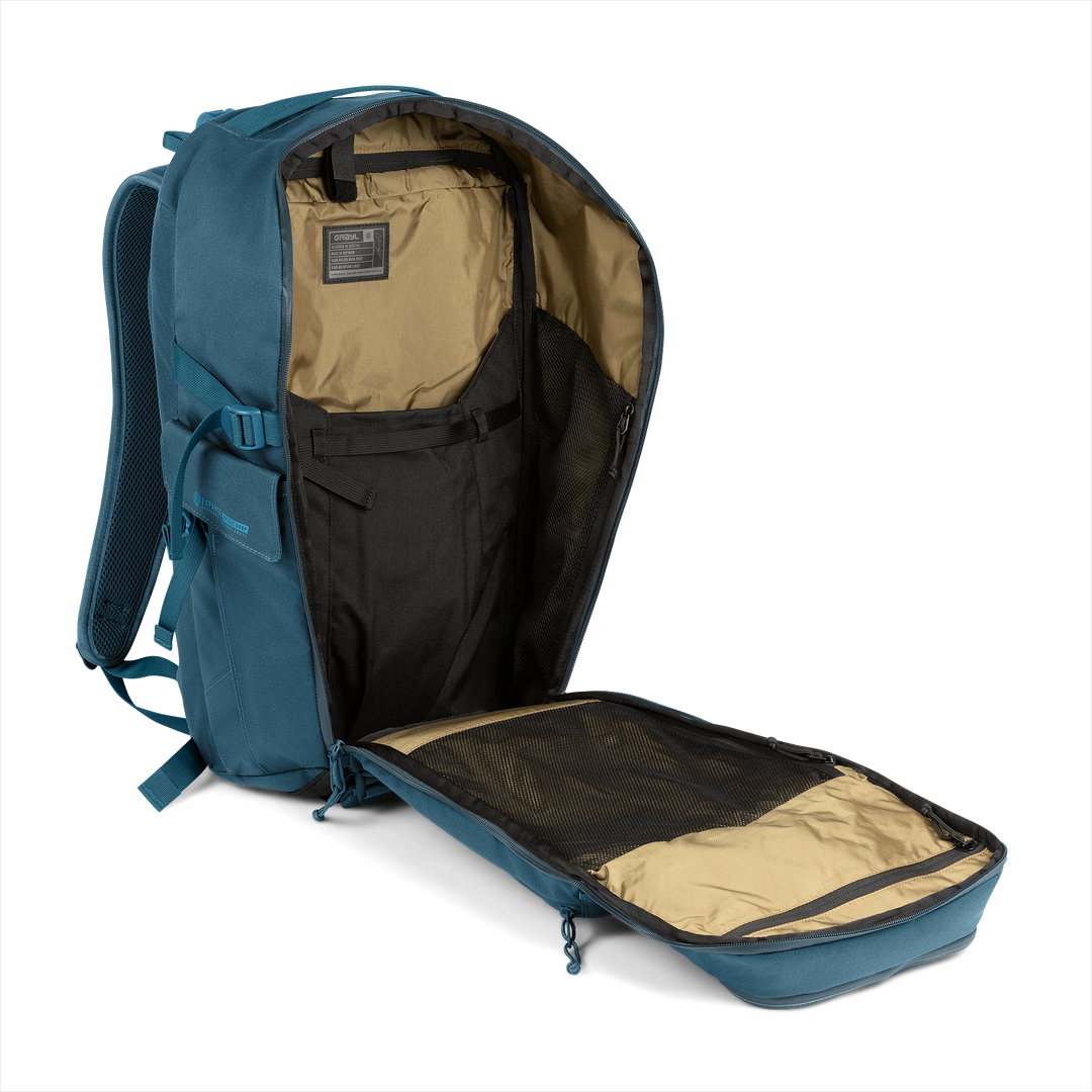 30L Transport Backpack (Wander Blue) with open compartment showing Coyote interior on a white background / Wander Blue