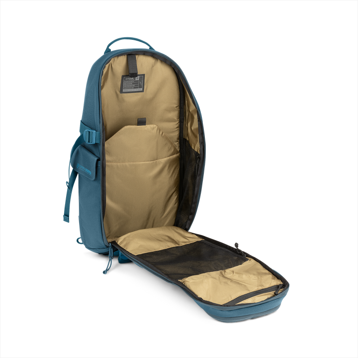 18L Transport Sling Daypack (Wander Blue) with open compartment showing Coyote interior on a white background / Wander Blue